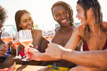Happy multiracial friends having fun drinking champagne at boat party outdoor - Summer and vacation concept - Main focus on african man face