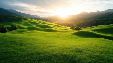 Obraz premium A serene green landscape with majestic mountains in the background and a soft golden sunrise, symbolizing peace, tranquility, and the beauty of nature.