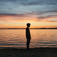 Silhouette of a Man at Sunset by the Water