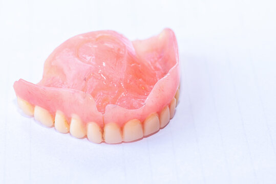 Old denture on a white background.