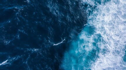 Aerial view of ocean waves, deep blue water contrasting with white foam, showing a dynamic ocean surface texture. Perfect for backgrounds or marine-themed designs. : Generative AI