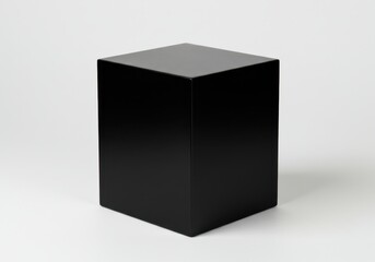 Simple studio shot of a black cube on a white background with a glossy finish