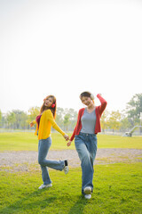 Fototapeta premium Happy Asian woman listening to music outdoors