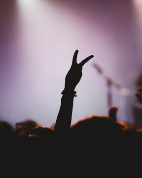 Silhouette of a Hand Showing Peace Sign at a Concert