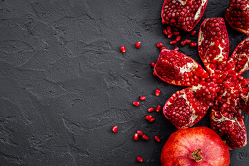 Top view of fresh ripe pomegranate with half and pieces ready for eating