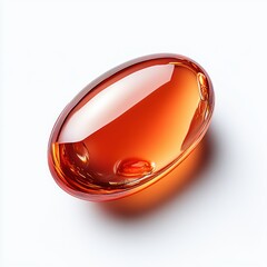 An amber colored transparent capsule sits on a white background, reflecting light with a smooth and glossy texture in a studio shot.