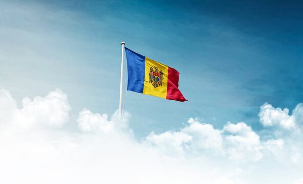Moldova national flag with mast waving in beautiful sky. Moldova flag for Republic Day and Independence Day.