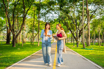 Obraz premium Study of portraits and female students at a university park to learn or study, scholarship books and laptops.