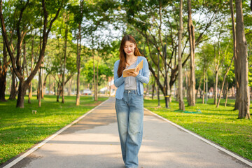 Study of portraits and female students at a university park to learn or study, scholarship books and laptops.