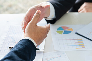 Close up of businessman hands agreeing to cooperate by shaking hands in unity of sustainability green nature business