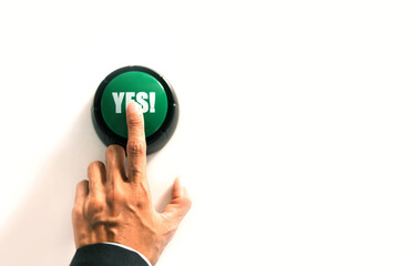 person presses the green button to confirm agreement, signaling approval and acceptance of a decision in voting or selection process.
