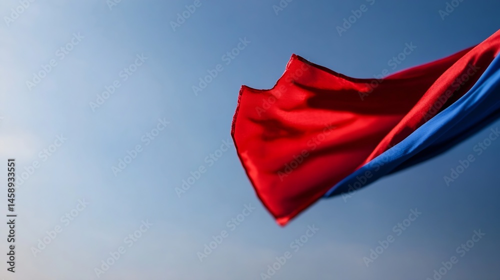 Aufkleber Red and blue fabric flowing in the wind against a clear blue sky, creating dynamic lines and folds.  The vibrant colors contrast beautifully with the serene background. : Generative AI