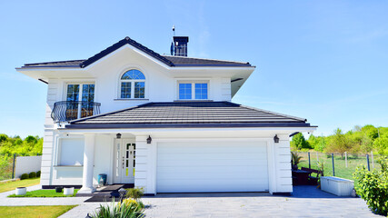 Luxury real estate single family house with white modern facade. A suburban district of single-family homes.