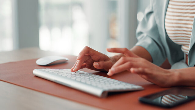 Hands, keyboard and typing with woman in office, story draft or article writing at desk. Closeup, computer and copywriting, review writer or email feedback with female employee at publishing startup