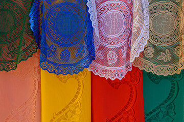 Colorful traditional lace fabrics hanging in a street market in Brazil
