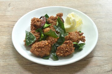 deep fried spicy chop pork ball Thai salad taste spicy and sour with cabbage on plate
