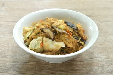fried glass noodles slice pork and cabbage with egg on bowl