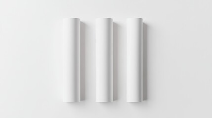Three blank cylindrical tubes on a white surface