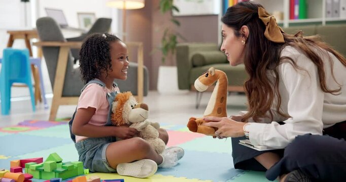 Happy, talking and toys with therapist and girl playing games for development, learning and story. Classroom, wellness therapy and fairy tale with kid, child student and woman with stuffed animal