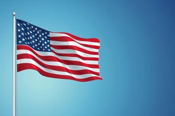 Obraz premium United States flag waving against a clear blue sky showcasing vibrant colors and design