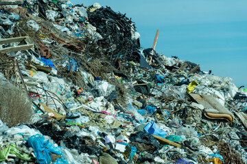 Overfilled landfill site showcasing discarded trash, plastic waste, and garbage creating an environmental concern pollution problem.