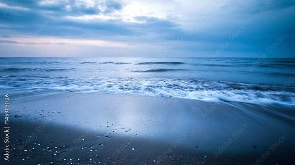Poster serene coastal scene at dawn, showcasing a tranquil ocean with gentle waves lapping a dark sandy bea