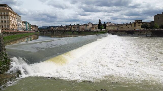 Europe, Italy, Florence - Drone aerial view Arno river  that crosses the Tuscan city in flood with water that risks flooding the historic center, flood and damage after the drought
