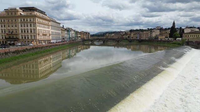 Europe, Italy, Florence - Drone aerial view Arno river  that crosses the Tuscan city in flood with water that risks flooding the historic center, flood and damage after the drought