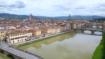 Europe, Italy, Florence , drone aerial view of Florence and Arno river - the Old Bridge , Ponte Vecchio , in city downtown  of the Middle Ages and Renaissance art - Tourist attraction destination 