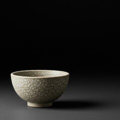 Elegant Craquelure Tea Bowl on Dark Background: A Study in Subtlety and Craftsmanship