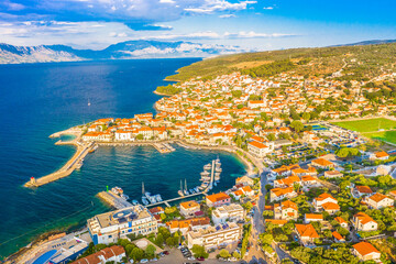 Scenic aerial photograph of the coastal village Postira on the northern shore of Brac Island in Croatia, showing its traditional stone houses, and Mediterranean surroundings