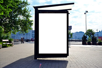 bus shelter at a busstop. blank billboard ad display. empty white lightbox sign. glass and aluminum structure. city transit station. urban street setting. white outdoor advertising mockup.