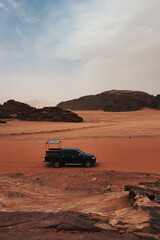 Fototapeta premium Wadi Rum Desert, Jordan. The red desert and Jabal Al Qattar mountain. 8th July 2023. On a hot spring cloudy day. 