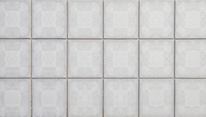 Decorative white tiles arranged in a clean geometric pattern  