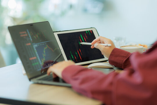 Professional male trader reviewing stock charts and financial data on a laptop in a tech-driven workspace — ideal for fintech, investment, and market analysis.