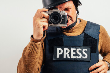 Reporter in bulletproof vest with a camera.