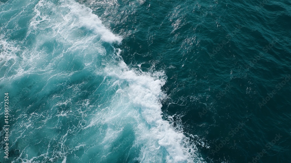 Poster aerial shot showcases the rolling ocean surface featuring rich turquoise hues and rhythmic waves, cr