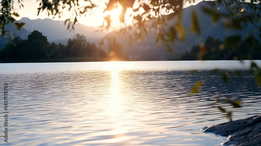 Poster serene sunset over a calm lake, mountains in the background, sun rays reflecting on the water's surf