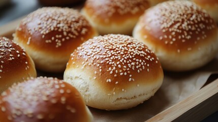 Golden, fluffy sesame-topped bread rolls, perfect for burgers, sandwiches, or as a side to meals. Soft texture and a lightly crisp crust