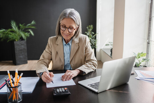 Mature Caucasian business woman manager working in office, audit analysis graph company budget report, assigned accounts receivable, production control, operational audit.