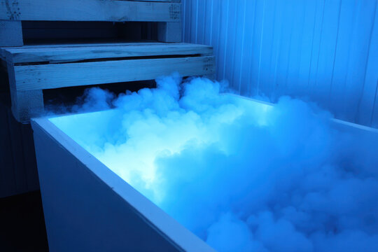 cryo chamber with swirling vapor emits cool blue glow