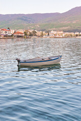 Naklejka premium Lake Ohrid, North Macedonia, April 13 2024. Mountain range and peninsula in distance. Ohrid Lake, Macedonia, Europe. The clear mesmerizing waters of lake Ohrid with a beautiful view. 