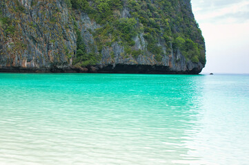 KOH PHI PHI, THAILAND - MARCH 11 2022: Motor boats on turquoise water of Maya Bay lagoon on MARCH 11, 2022 in Koh Phi Phi island, Thailand. This was extremely quiet due to the Covid 19 pandemic.