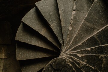 A close-up view of a stone spiral staircase, showcasing its intricate design and worn texture