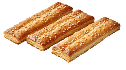 Three sesame-topped puff pastry sticks on a transparent background, close up