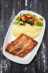Braised ribs with potato puree and salad