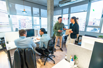 Obraz premium Diverse businesspeople collaborating in modern office with wheelchair user