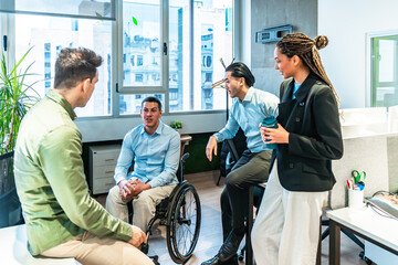 Diverse business team discussing during meeting in modern office with disabled colleague