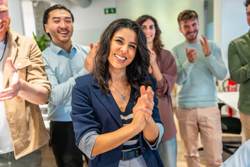 Obraz premium Happy business team clapping and celebrating success in office meeting