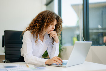 Obraz premium Successful businesswoman in office working on laptop.for doing math finance on an office desk, tax, report.